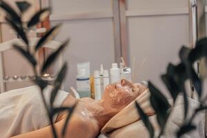 Woman Enjoying a Relaxing Facial Treatment in a Spa photo