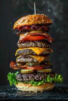 Stacked Cheeseburger with Multiple Beef Patties, Bacon, and Fresh Vegetables photo