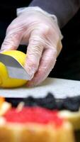 black caviar lemon on a black slate board close up, freshly sliced lemon on a black board video