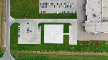 Car parking on a modern plant. Factory on green field with many cars on parking spaces. Camera rising up. video