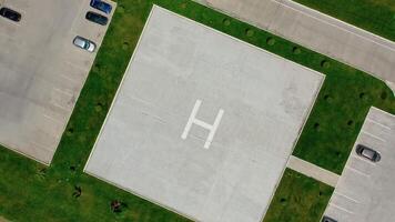Empty parking space. Square place for parking cars with the letter H in the center. Modern parking on field. Top aerial view. Motion down. video