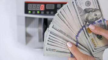 Hundred dollar bills in female's hands. Much american paper money in hands on the background of electronic calculating machine. Close-up. video