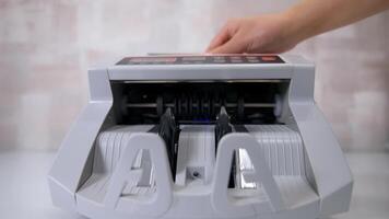 Currency counting machine counts dollar bills. Money counting equipment for paper money calculation. Currency exchange of one hundred dollars. Front view. video