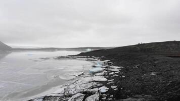 group of photographer shooting iceland landscape in overcast day by glacier video