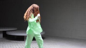 Dynamic Dance Movements in Vibrant Green Attire with expressive choreography and energetic motion video