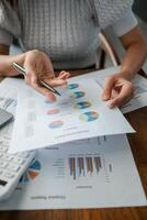 Close-up of a person reviewing financial charts and graphs, highlighting data analysis and business strategy. photo