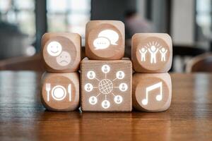 Wooden blocks with icons representing different cultural concepts like communication, music, and social interaction. photo