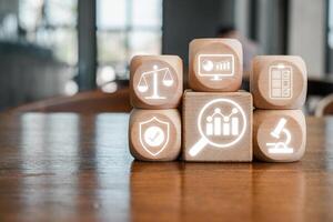 Wooden blocks with digital icons representing data analysis, business intelligence, and technology solutions on a wooden table. photo