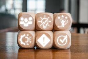 Wooden blocks with icons symbolizing service innovation, creativity, technology, and customer satisfaction. photo