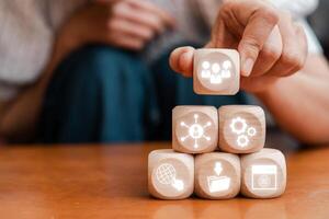 Wooden blocks with digital icons symbolize user-generated content and online community building in a modern digital context. photo