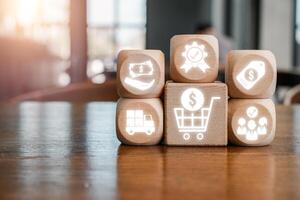 Creative representation of the purchasing process using wooden blocks with shopping and finance icons. photo