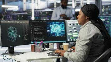 Data center admin does machine learning node tree programming, optimizing resource allocation. Server room worker uses predictive artificial intelligence visualization systems for maintenance, camera B video