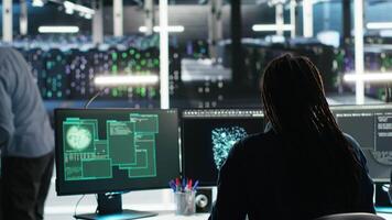 Server hub engineering team rushes to stop cyberattack targeting confidential information. Data center colleagues working together during security breach to contain virus and protect systems, camera B video