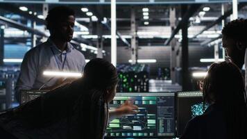 Server hub engineering team working together, using node tree software to optimize system health. Data center teamworking colleagues brainstorming equipment issues using AI visualization, camera B video