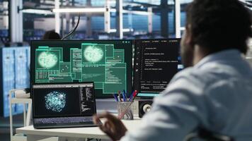 Man with paraplegia in server hub trying to protect hardware from hacker attack stealing sensitive information. Data center specialist in wheelchair fighting virus during security breach, camera B video