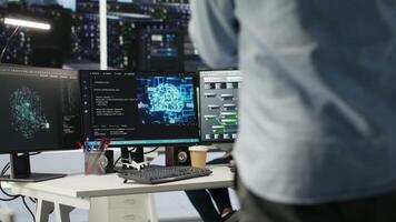 Server hub engineering team interprets data analytics graphs. Teamworking data center colleagues using artificial intelligence program showing predictive system metrics, camera B video