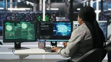 Technicians in AI server hub collaborate to protect against data theft during active threat. Data center team working together to safeguard equipment and systems during security breach, camera B video