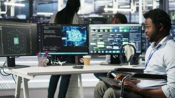 Stressed engineer with paraplegia in data center panicked by AI node tree software critical error. Anxious server hub worker in wheelchair worried by visual programming tool glitching, camera B video