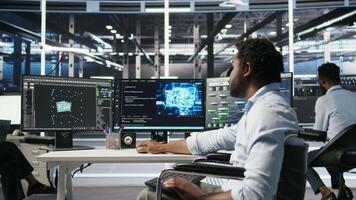 Overworked man in wheelchair upset by error warning popup while looking at server hub AI analytics metrics. Data center worker with disability irked by malfunction while using node tree tool, camera A video