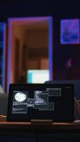Vertical Black IT professional in loft working on cybersecurity with gadgets, tackling hacking attempts, encryption and cyber defense. Screen shows security breach warning, data security risks. Camera A. video