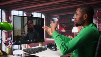 Male worker calls manager remotely using internet call to ask for feedback on project progress. Teleworker requesting assistance from team leader in teleconference meeting. Camera B. video