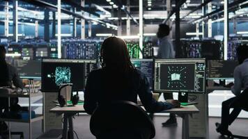 Data center engineer using algorithms to analyze large datasets, putting on headphones. Server farm IT professional using artificial intelligence to recognize data patterns listening music, camera A video