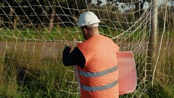 Engineer Fixing The Net Of The Football Pitch video