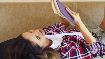 Young girl immersed in a captivating book video