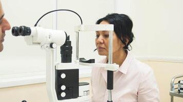 Patient prepares for eye examination with advanced diagnostic device video