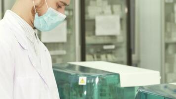 Focused lab technician analyzing results with precision video