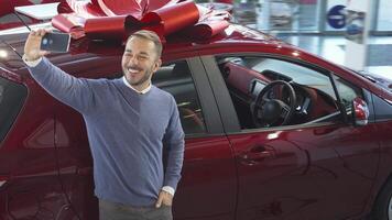 Charming man taking a selfie with a shiny new car video