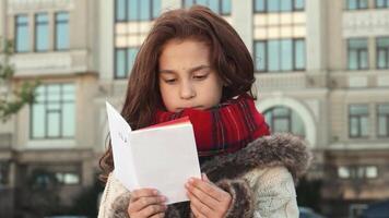 Upset girl struggles to find her way on a map in the bustling city video
