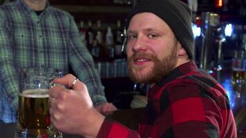 Bearded guy turns back with a frosty glass of beer video