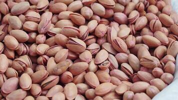 Pistachio nuts in a woven basket for sale at a local market video