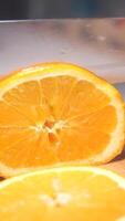 Slicing fresh oranges for a refreshing drink in sunny kitchen video