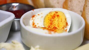 Delicious boiled eggs served with bread and spreads at breakfast table video