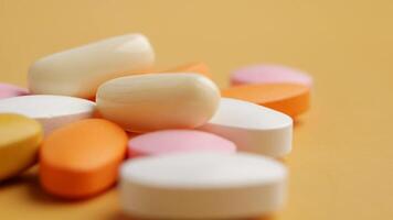 Different types of medicine and supplements on a yellow surface video