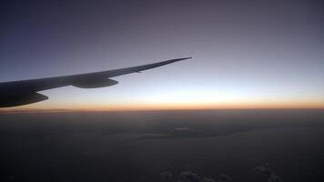 Sunset view from airplane wing during twilight flight video
