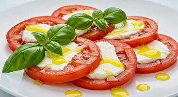 A plate of tomatoes with mozzarella and basil photo