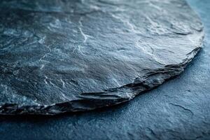 Elegant Black Stone Table Top Against a Vibrant Blue Background Perfect for Modern Interiors photo