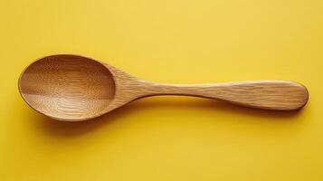 A Simple Wooden Spoon Ideal for Cooking and Baking Set Against a Soft Pastel Yellow Background Perfect for Culinary Blogs or Kitchen Decor photo