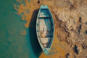 Aerial View of a Stranded Fishing Boat on a Remote Shoreline Illustrating the Dangers of Maritime Activities photo