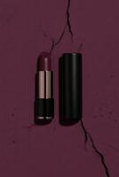 Dark plum lipstick on cracked surface photo