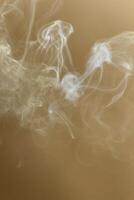Swirling smoke on warm background photo