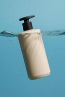 Minimalistic close-up of a beige plastic pump bottle with a black dispenser floating partially submerged in clear water, set against a vibrant blue background. photo