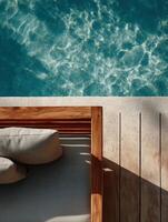 A minimalist top-down view of a wooden poolside lounger with soft beige cushions, placed on a pale stone surface next to a clear turquoise pool. photo
