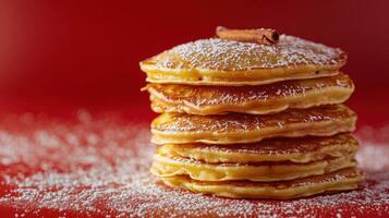 A Delicious Stack of Cinnamon Pancakes Served on a Bright Red Plate Perfect for Breakfast or Brunch Arrangements photo