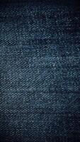 Stylish dark blue denim texture. Looping stop-motion effect vertical animation. video