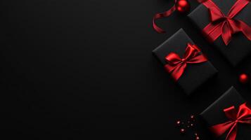 Three black boxes with red bows on top of a black background photo