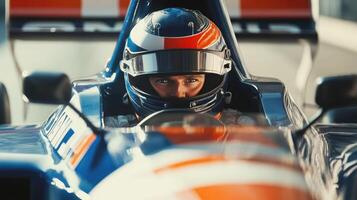 driver in helmet sits behind the wheel of a car close-up and looks at the camera photo